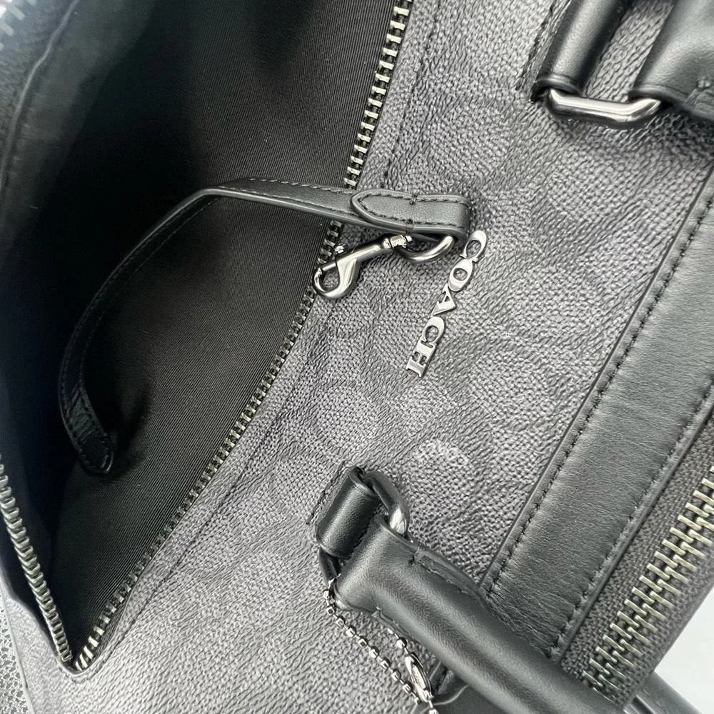 Coach Slim Brief In Signature Canvas With Trolley Sleeve